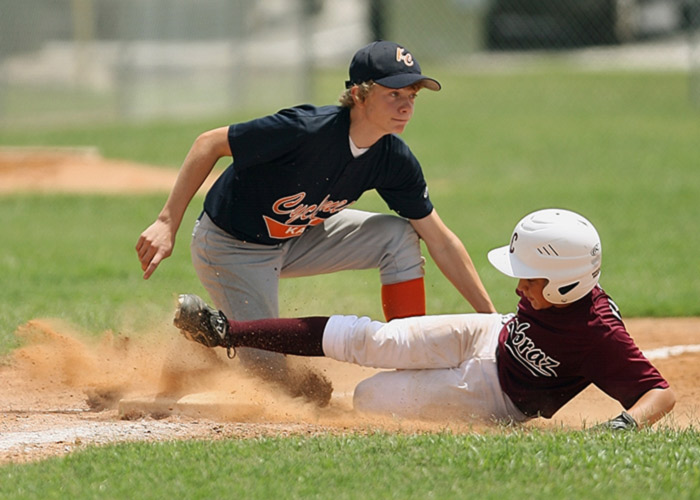 Young baseball player sliding into a base