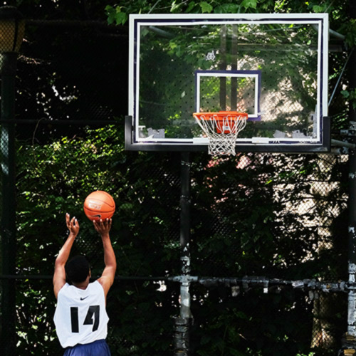 Person playing basketball in a park