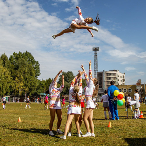 Cheerleaders doing a routine at a park