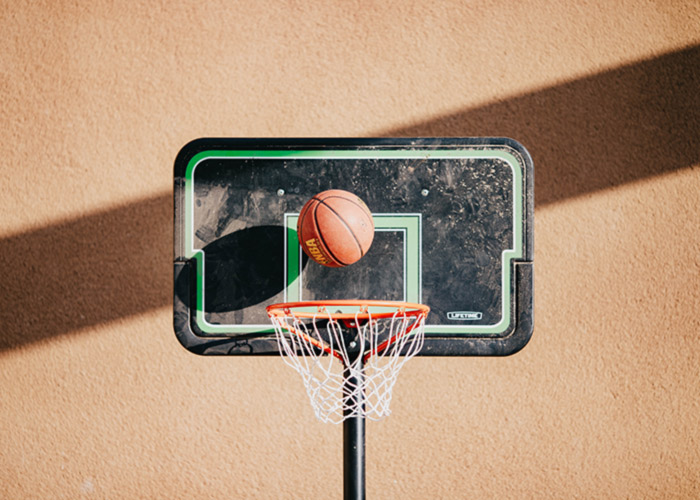 Basketball going through a basketball goal