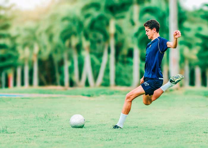 soccer player kicking ball